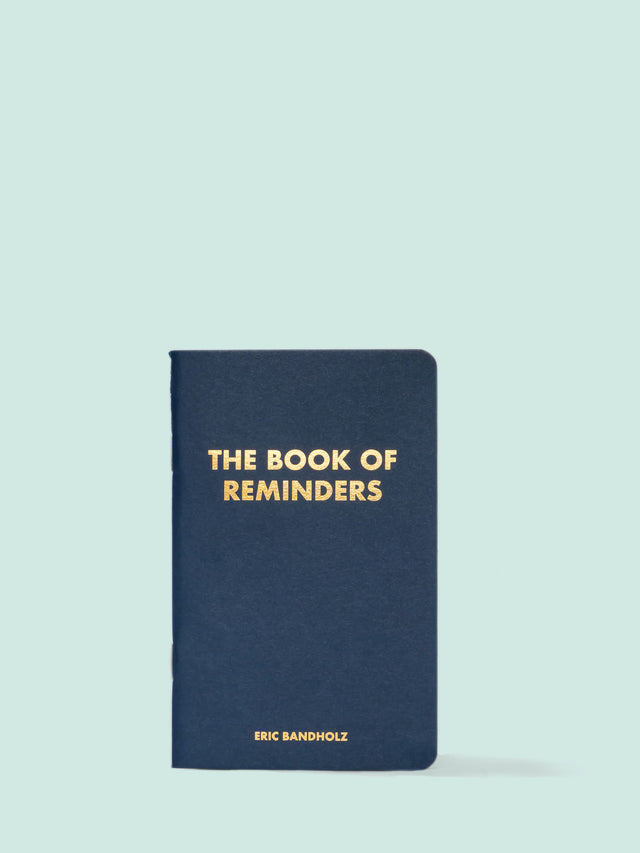 The Book of Reminders by Eric Bandholz on a striking blue backdrop.