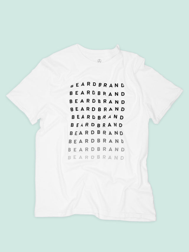 A white Beardbrand Forever Tee with "Beardbrand" in black ink at top repeated until fades to light gray on the front.